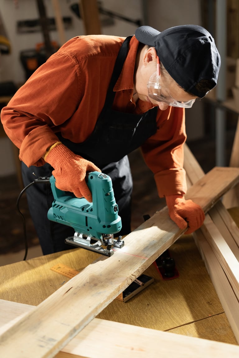 Female carpenter using a jigsaw to cut wood in her workshop, demonstrating precision and craftsmanship in woodworking projects.